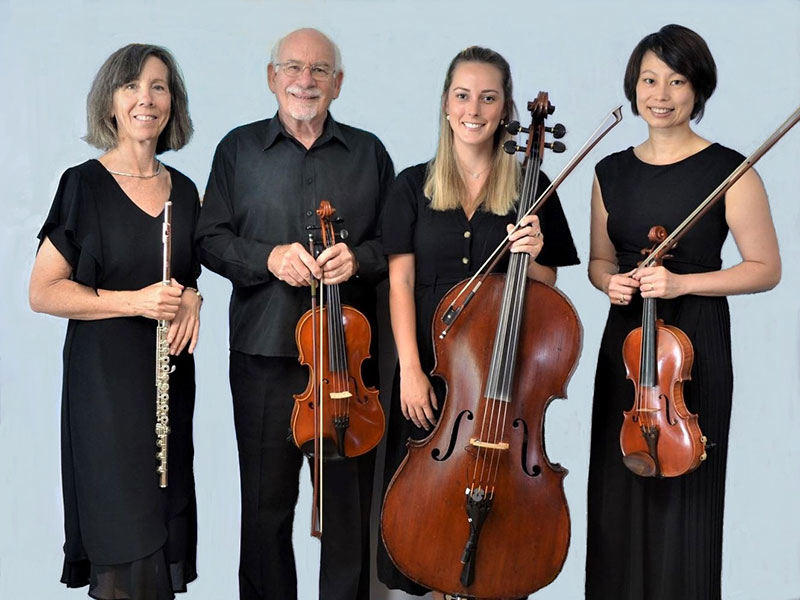 Photo of four performers holding instruments – from left – Jennifer St George- Flute, James Ferguson – Viola, Helen Griffith- cello, and Catherine Sheng-Cooper – Violin.